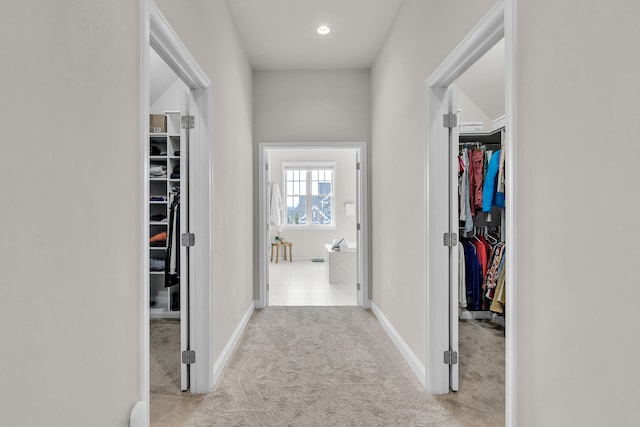 hall with carpet floors and baseboards