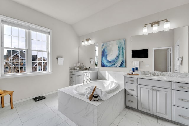 bathroom featuring lofted ceiling, marble finish floor, two vanities, and a sink