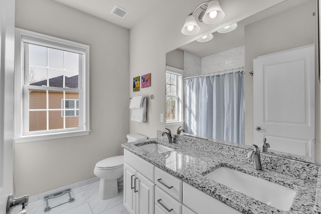 bathroom featuring toilet, marble finish floor, a sink, and visible vents