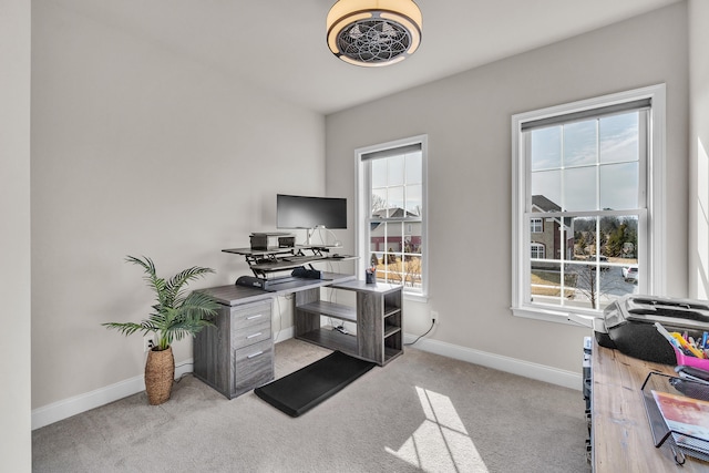 home office featuring baseboards and light colored carpet