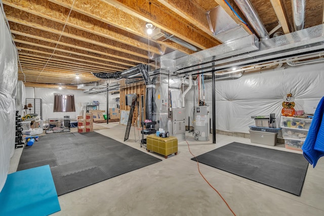 unfinished basement featuring water heater and heating unit