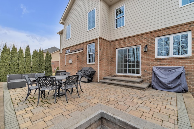 view of patio / terrace featuring entry steps, a grill, and an outdoor living space