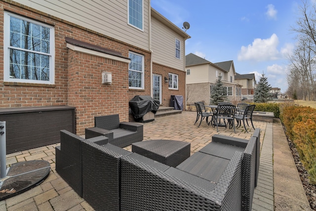 view of patio featuring a residential view, a grill, and an outdoor living space