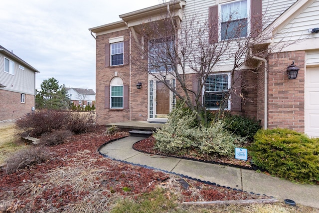 entrance to property featuring brick siding