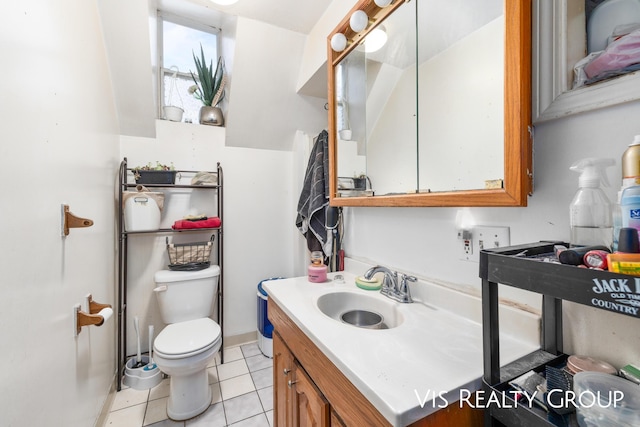 bathroom with vanity, toilet, and tile patterned floors