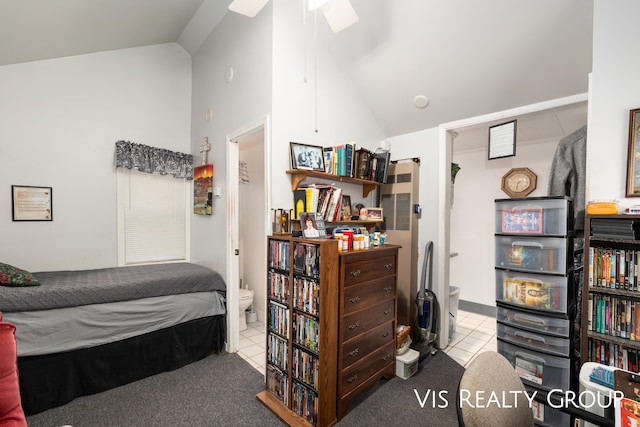 bedroom featuring high vaulted ceiling, connected bathroom, and tile patterned floors