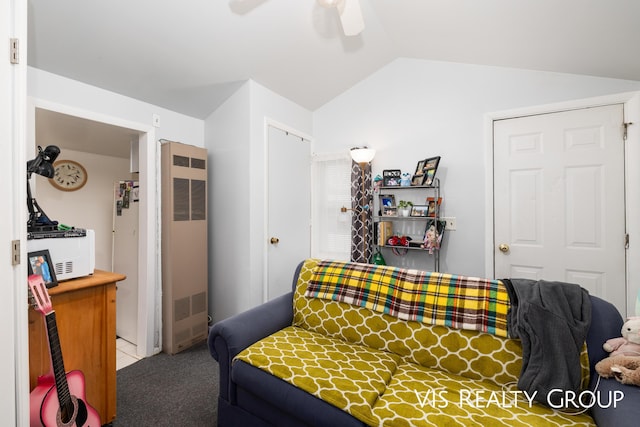 bedroom with vaulted ceiling, a heating unit, carpet flooring, and a ceiling fan