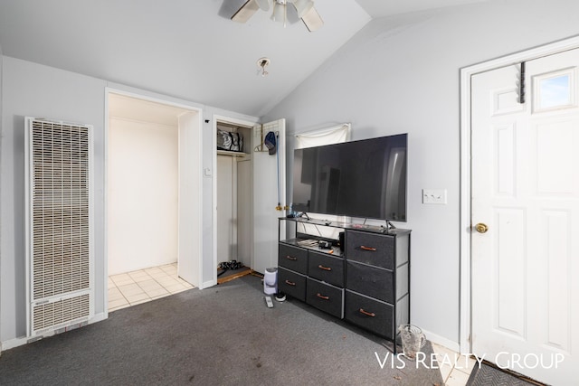 carpeted bedroom with lofted ceiling, baseboards, a heating unit, and a ceiling fan