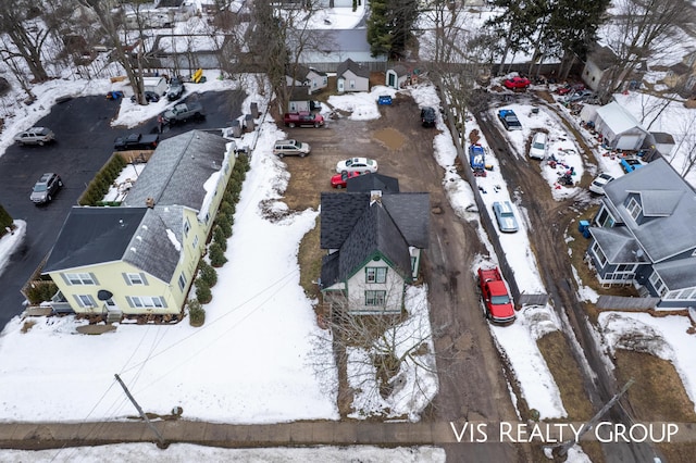 snowy aerial view with a residential view