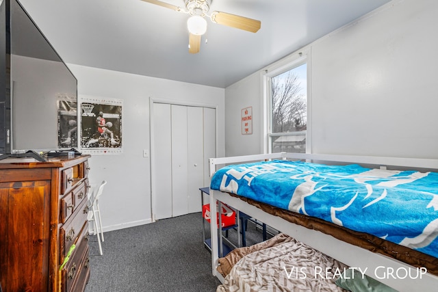 bedroom with dark colored carpet, a closet, and a ceiling fan