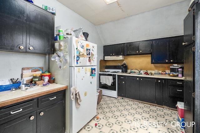 kitchen with dark cabinets, white appliances, light countertops, and under cabinet range hood