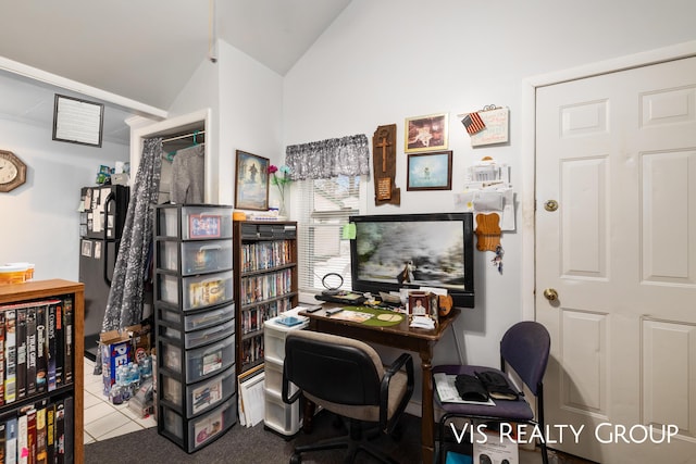 tiled office featuring vaulted ceiling