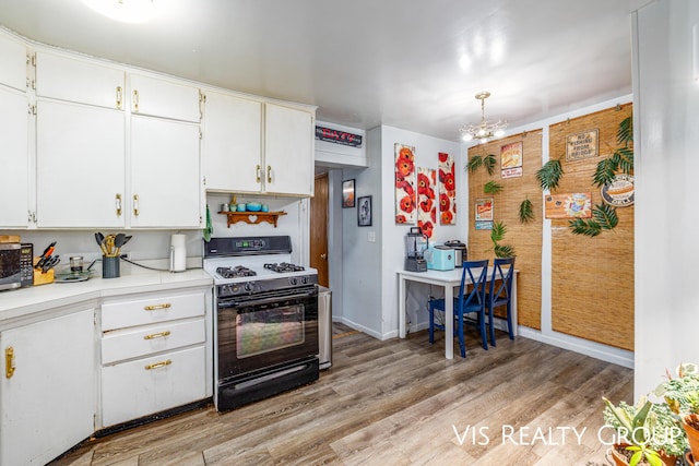 kitchen with white cabinets, light wood-style floors, light countertops, and range with gas cooktop