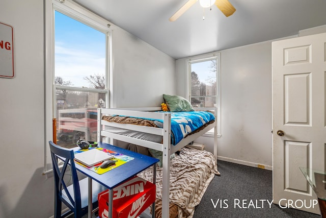 carpeted bedroom with a ceiling fan, vaulted ceiling, and baseboards