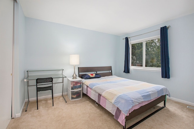 bedroom featuring carpet floors, visible vents, and baseboards