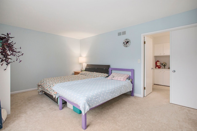 bedroom with baseboards, visible vents, and light colored carpet