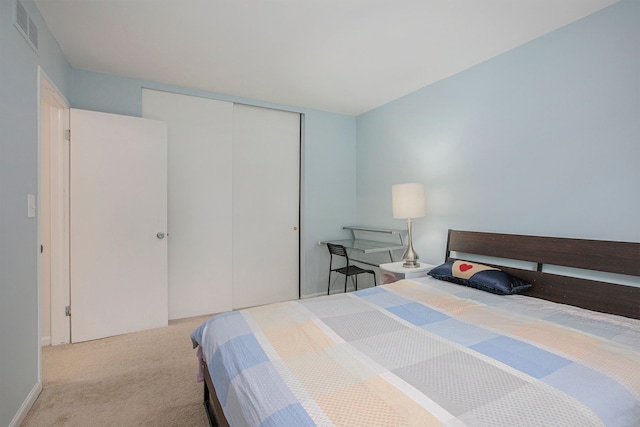 bedroom featuring carpet floors, a closet, and visible vents