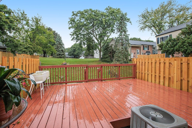 deck with central AC, a yard, and fence