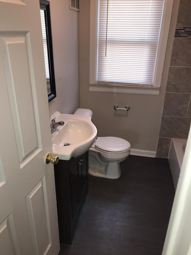 full bath with a washtub, visible vents, toilet, vanity, and walk in shower