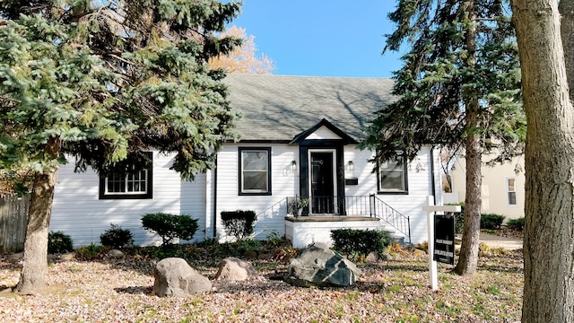 view of front facade featuring roof with shingles