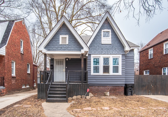 view of front of house with a porch and fence