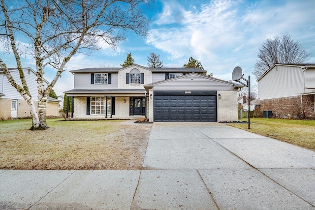 traditional home with brick siding, a porch, a garage, driveway, and a front lawn