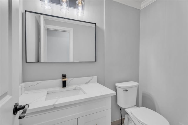 half bathroom with vanity and toilet