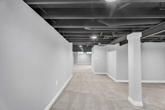 basement with carpet flooring and baseboards