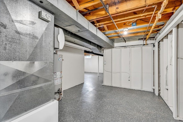 basement featuring gas water heater and heating unit