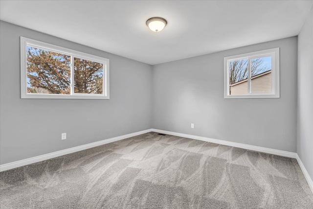 empty room with carpet floors and baseboards