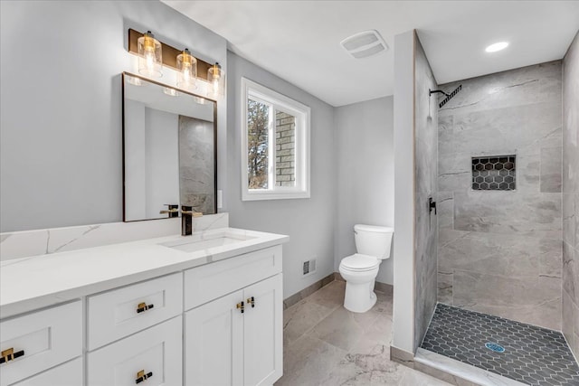 bathroom with baseboards, visible vents, a tile shower, and toilet