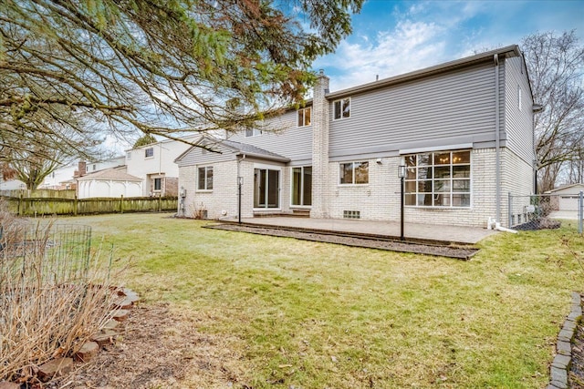 back of property featuring a patio area, fence, and a lawn