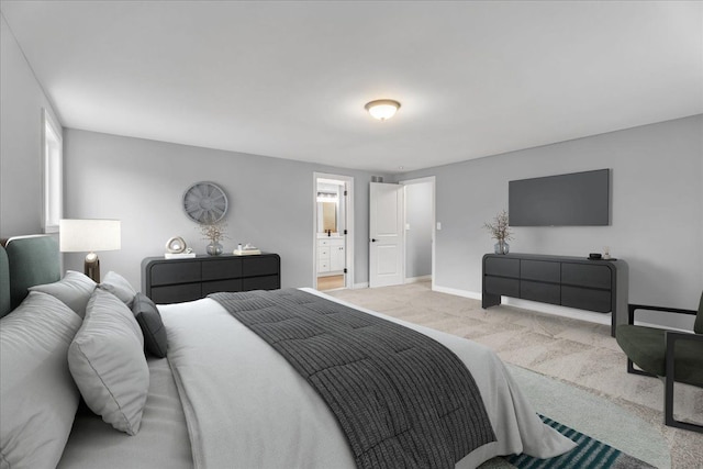 bedroom featuring carpet, ensuite bath, and baseboards