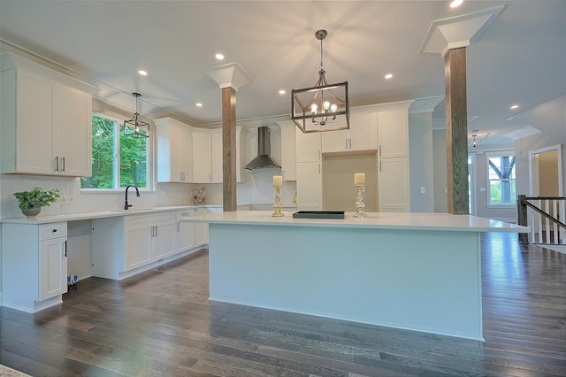 kitchen featuring dark wood-style floors, a wealth of natural light, white cabinets, and wall chimney exhaust hood