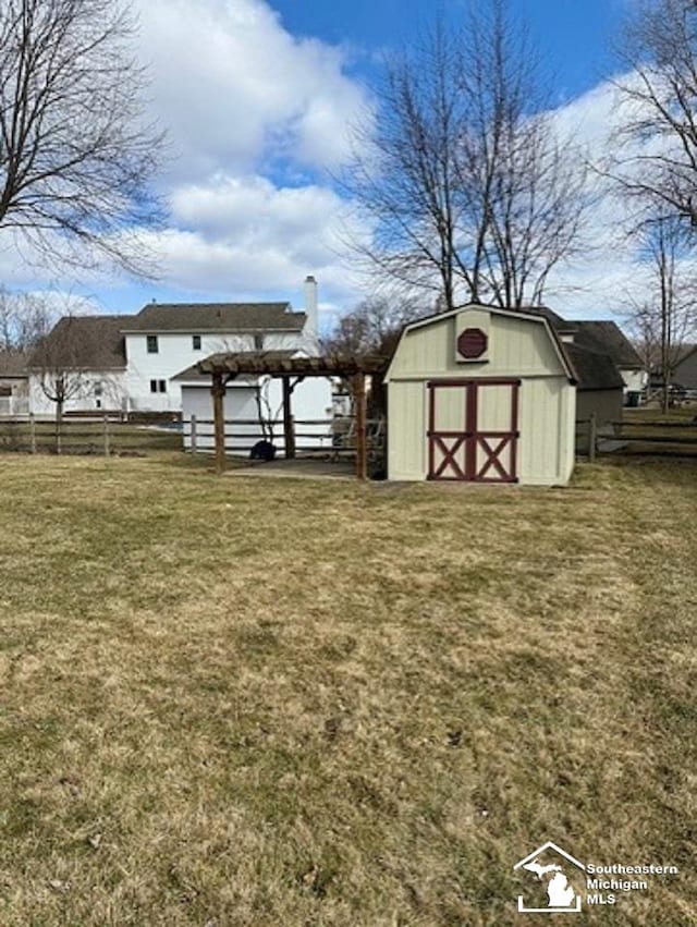 view of yard featuring a storage shed, an outdoor structure, and fence