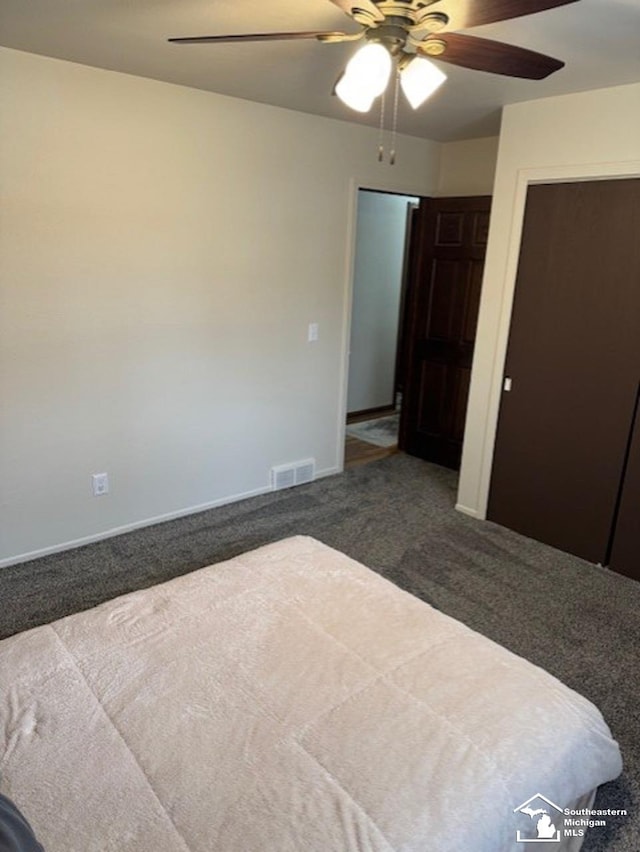 bedroom featuring ceiling fan, visible vents, dark colored carpet, and baseboards