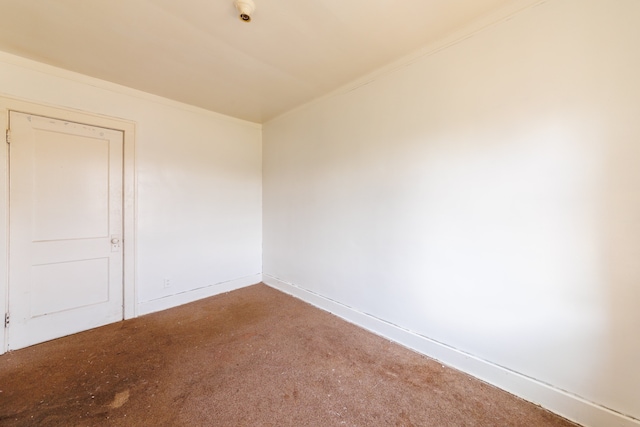 empty room featuring baseboards