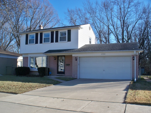 view of front of house with a garage, brick siding, concrete driveway, a chimney, and a front yard