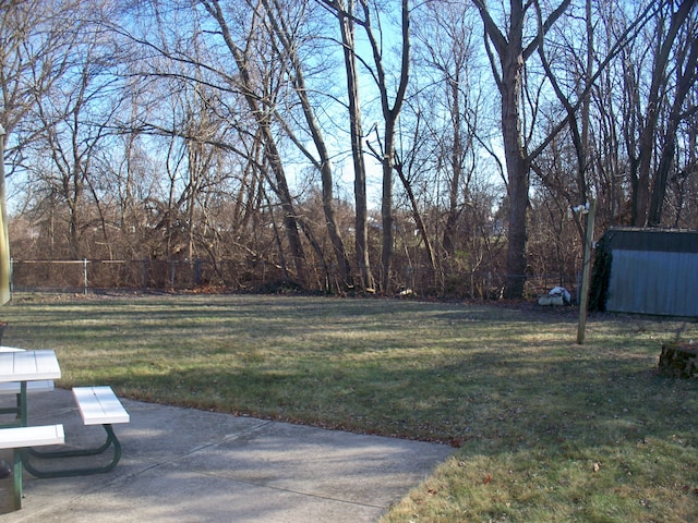 view of yard with fence and a patio