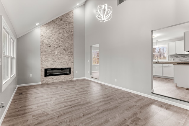 unfurnished living room with a healthy amount of sunlight, light wood-style floors, and a fireplace