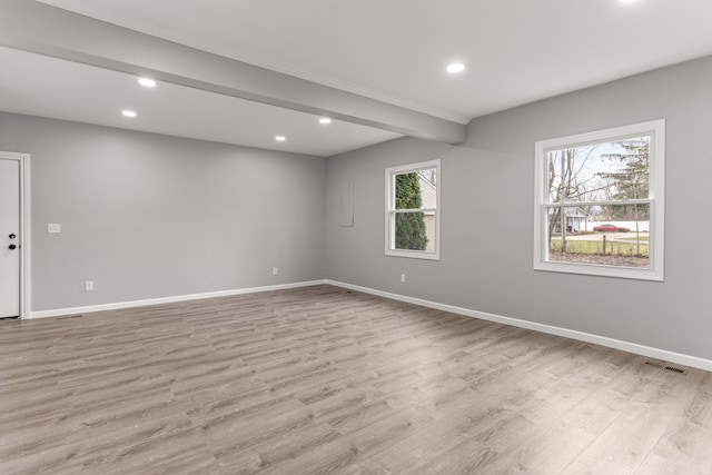 spare room with visible vents, baseboards, light wood-style flooring, beamed ceiling, and recessed lighting