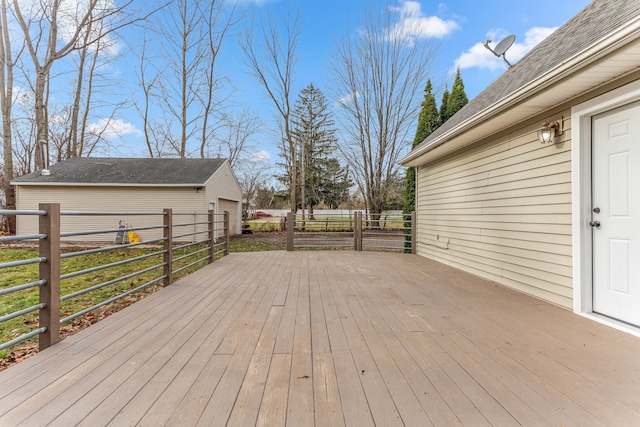 wooden terrace with an outdoor structure and fence