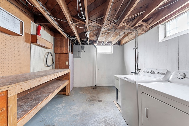 basement featuring a workshop area, independent washer and dryer, and electric panel