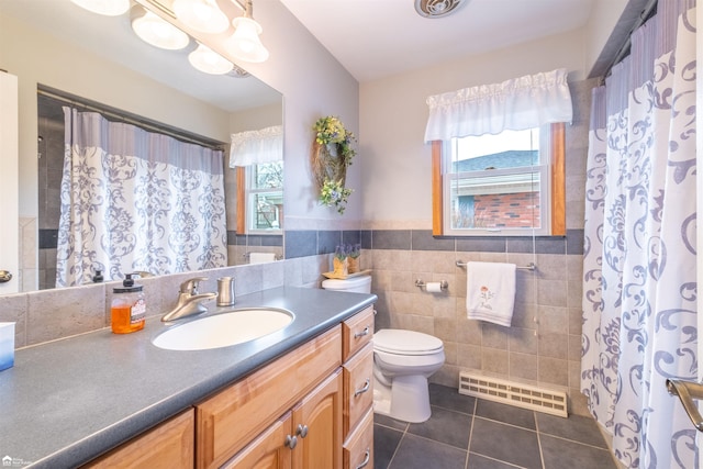 full bathroom featuring tile patterned flooring, toilet, vanity, visible vents, and tile walls