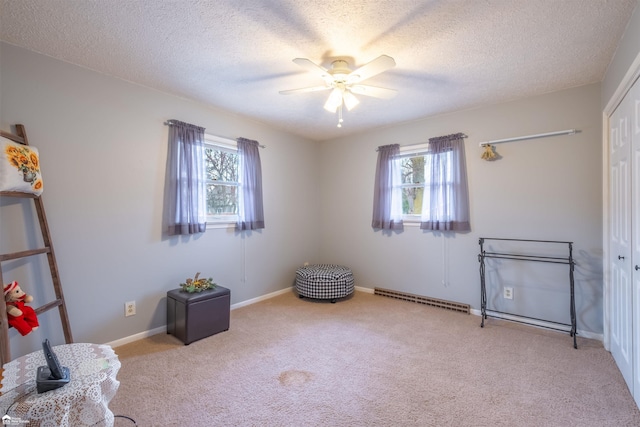 unfurnished room featuring carpet floors, a textured ceiling, visible vents, and a ceiling fan