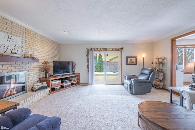 living room with a healthy amount of sunlight, crown molding, a fireplace, and a textured ceiling