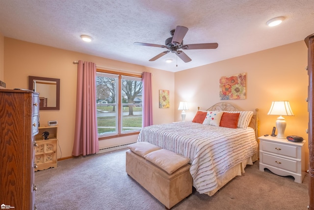 carpeted bedroom featuring a ceiling fan, a baseboard radiator, and a textured ceiling