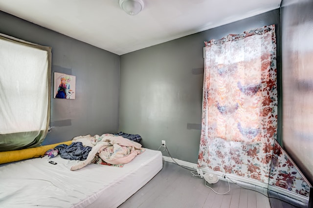 bedroom with wood finished floors and baseboards