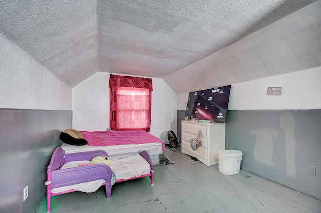 bedroom with a textured ceiling and vaulted ceiling