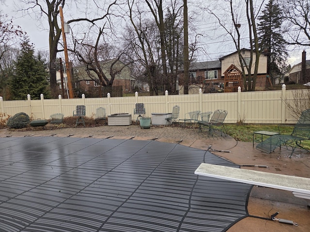 view of swimming pool featuring fence and a patio